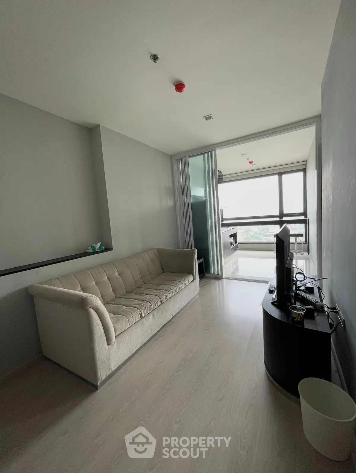 Modern living room with sleek design and large windows offering natural light and scenic views.