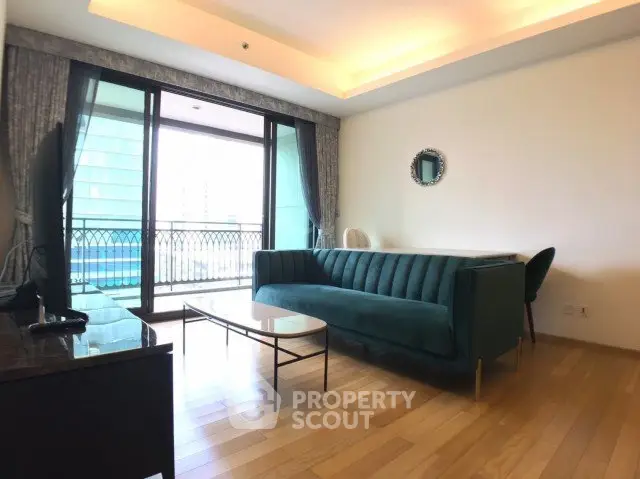 Spacious living room with elegant sofa and large balcony access in modern apartment.