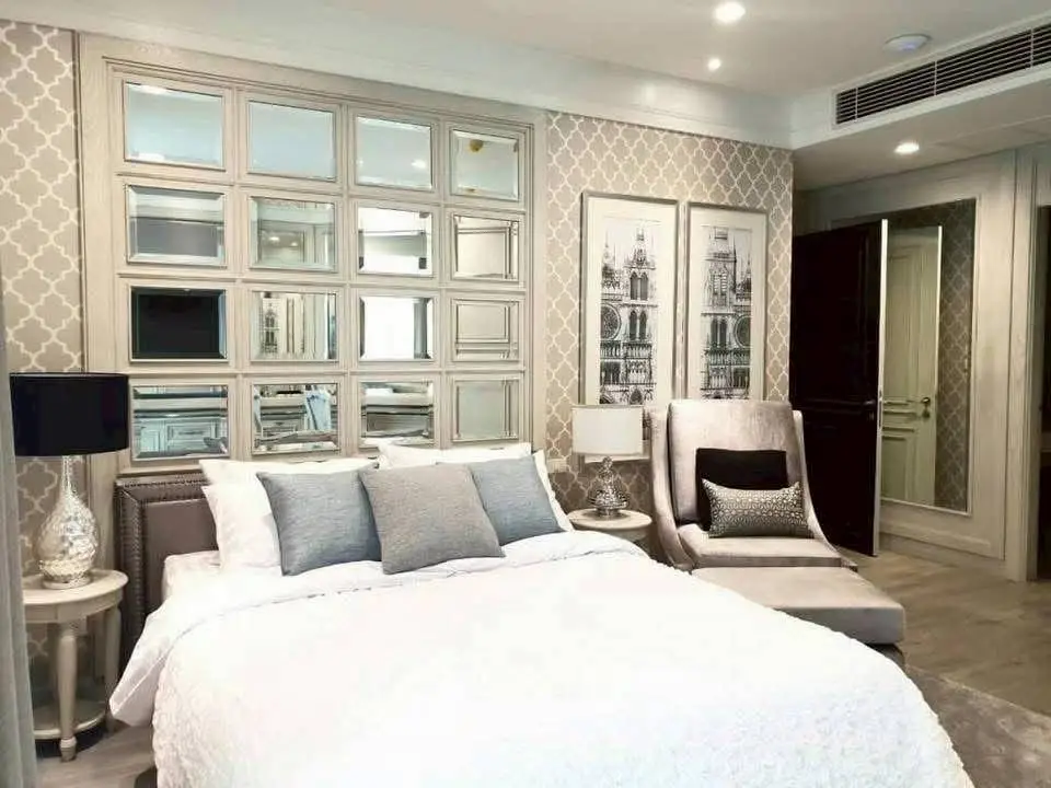 Luxurious bedroom with elegant decor and mirrored wall accents
