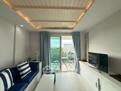 Stylish living room with balcony view, modern decor, and ample natural light.
