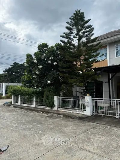 Charming suburban house with lush greenery and modern design, perfect for family living.