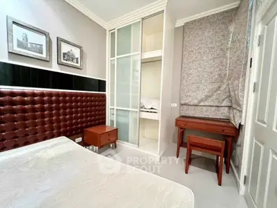 Cozy bedroom with stylish headboard and built-in closet in modern apartment