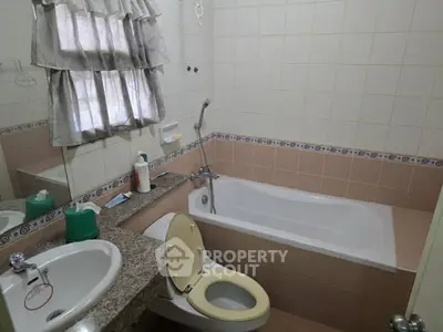 Cozy bathroom with bathtub and tiled walls, featuring a granite countertop and classic fixtures.