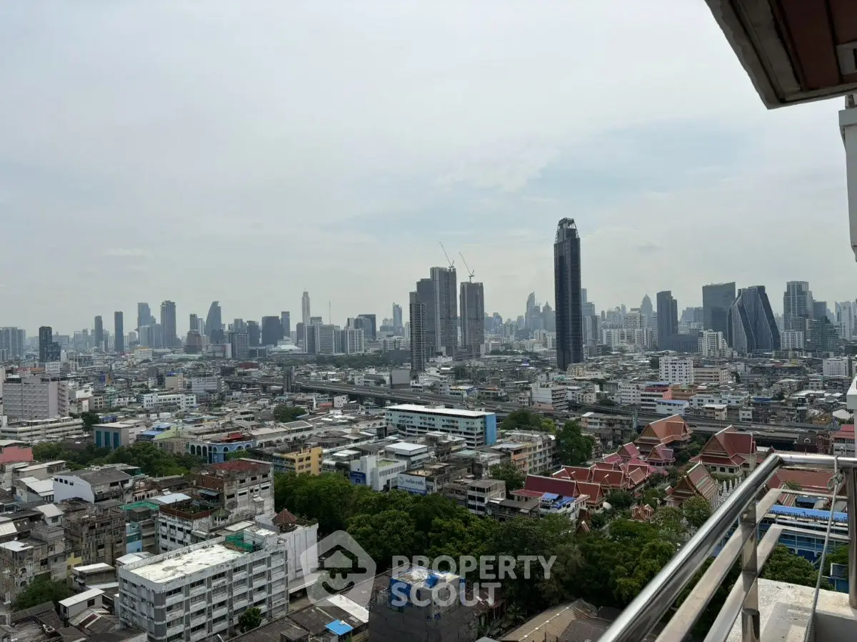 Stunning cityscape view from high-rise balcony overlooking urban skyline.
