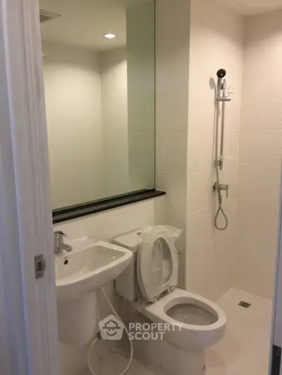 Modern bathroom with sleek fixtures and a spacious shower area, perfect for contemporary living.