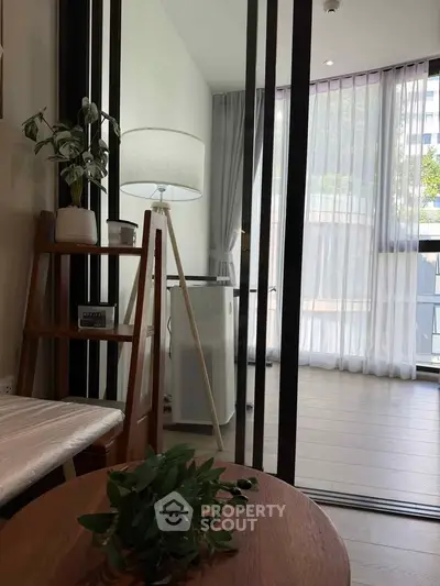 Modern living room with stylish decor and large windows offering natural light