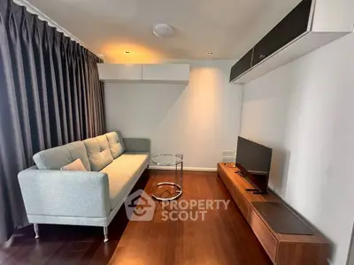 Modern living room with sleek furniture and wooden flooring