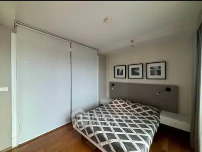 Modern bedroom with stylish decor and cozy ambiance, featuring a double bed and contemporary artwork.