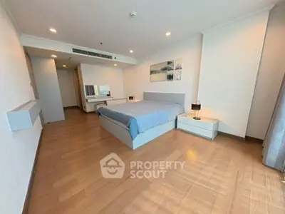 Spacious modern bedroom with elegant decor and wooden flooring