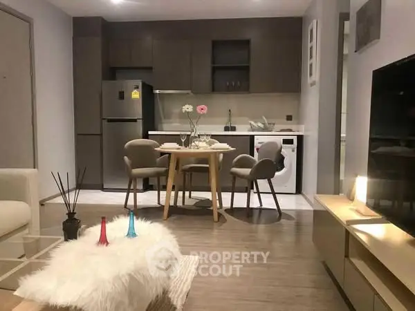 Modern open-plan living room with stylish kitchen and cozy dining area.