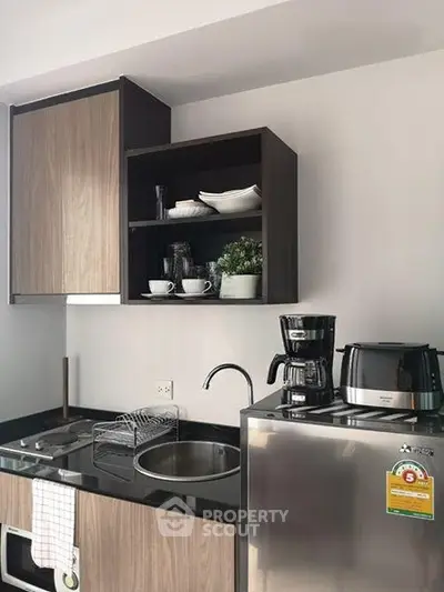 Modern kitchen with sleek cabinets, stainless steel appliances, and stylish countertop.