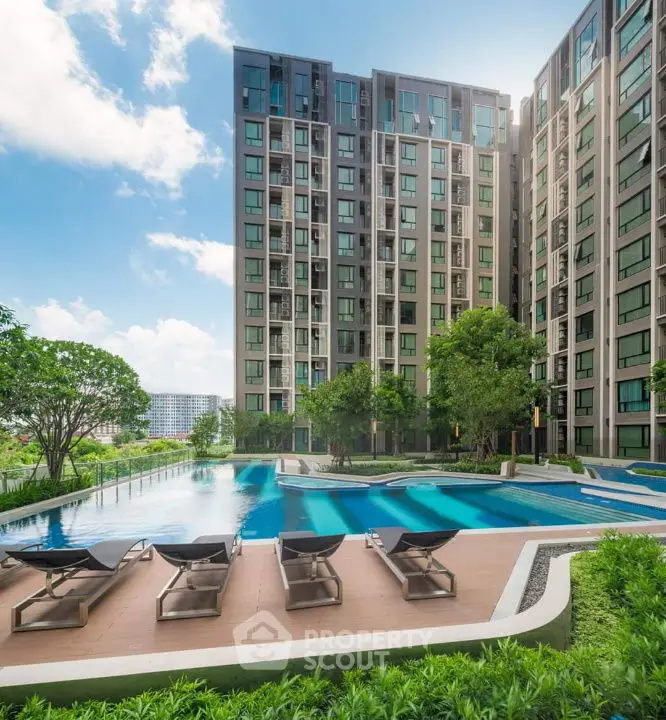 Luxurious modern apartment complex with stunning pool and lush greenery