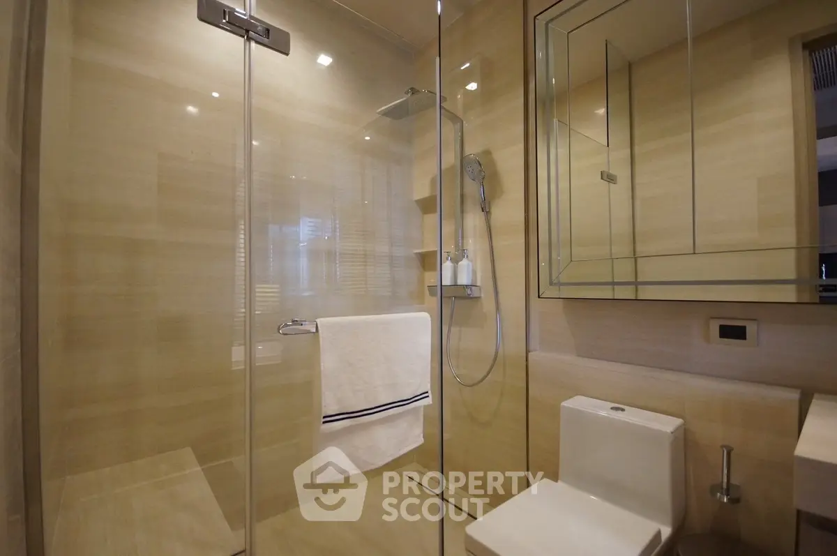 Luxurious modern bathroom with glass shower and elegant fixtures