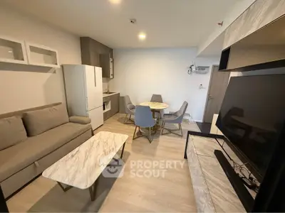 Modern living room with stylish furniture and open kitchen layout
