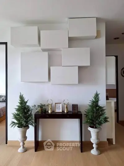 Modern interior with unique wall decor and elegant console table, perfect for stylish living spaces.