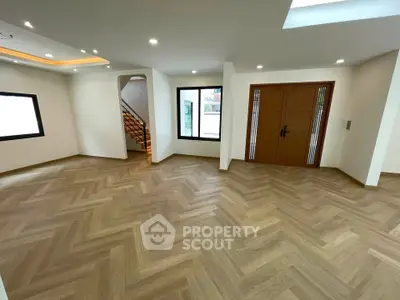 Spacious modern living room with elegant wooden flooring and stylish lighting