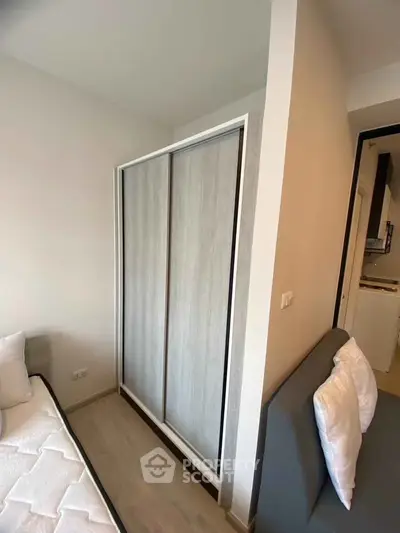 Cozy bedroom with modern wardrobe and comfortable bed in a stylish apartment.