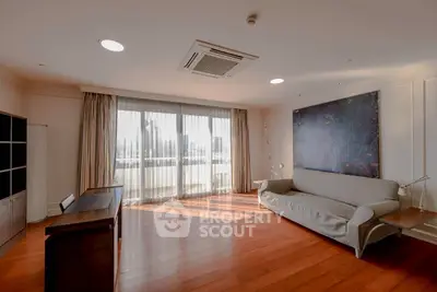 Spacious living room with large windows and modern decor in a luxury apartment.