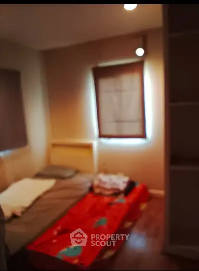 Cozy small bedroom with single bed and soft lighting, perfect for minimalist living.
