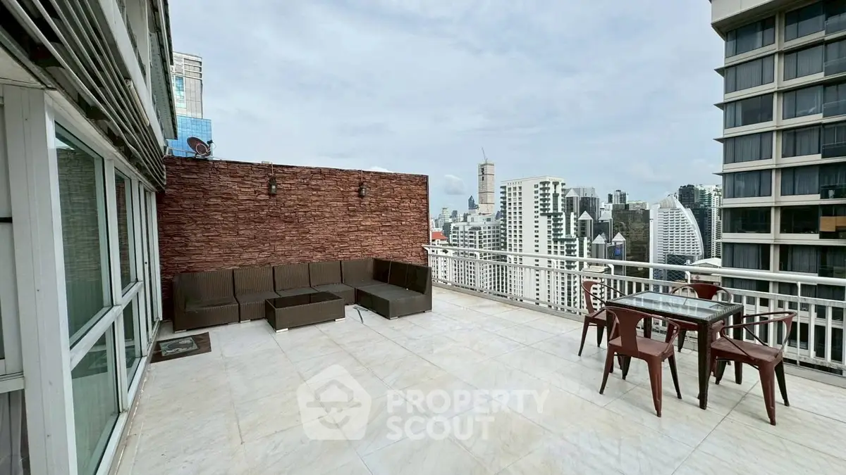 Spacious rooftop terrace with stunning city skyline views and outdoor seating area.