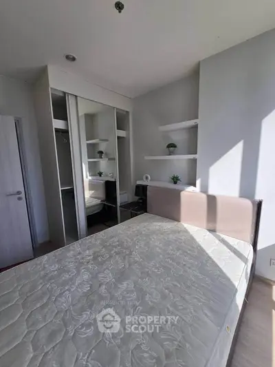 Modern bedroom with mirrored closet and natural light
