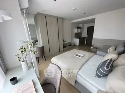 Modern bedroom with elegant decor and cozy ambiance in a stylish apartment.