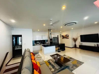 Spacious modern living room with open kitchen and stylish decor