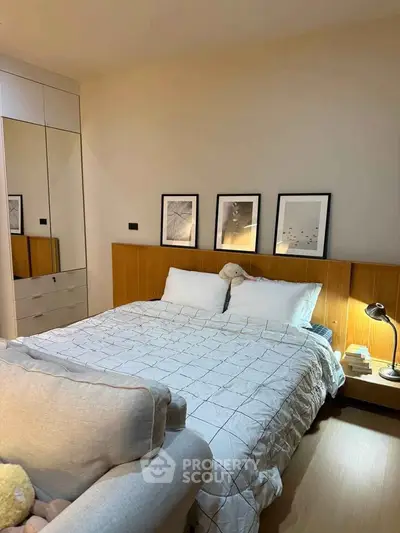 Cozy bedroom with modern decor and ample storage in a stylish apartment.