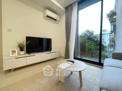 Modern living room with sleek furniture and large balcony window offering natural light.