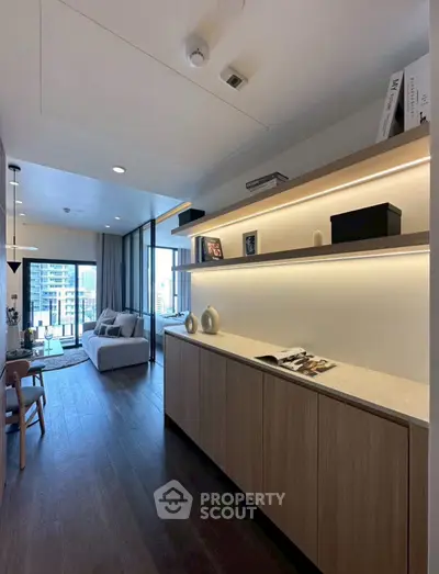 Modern living room with stylish decor and city view, featuring sleek furniture and ambient lighting.