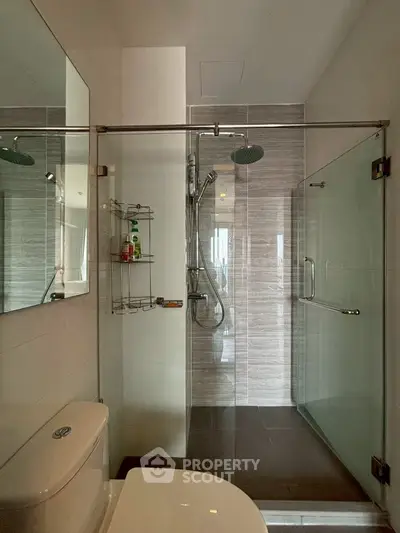 Modern bathroom with glass shower enclosure and sleek fixtures