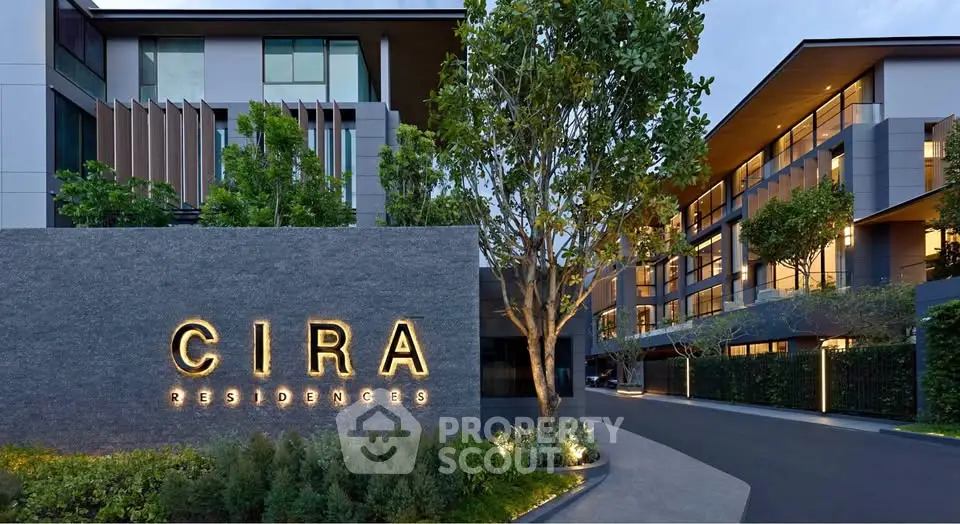 Luxurious modern apartment complex with elegant facade and lush greenery at Cira Residences.