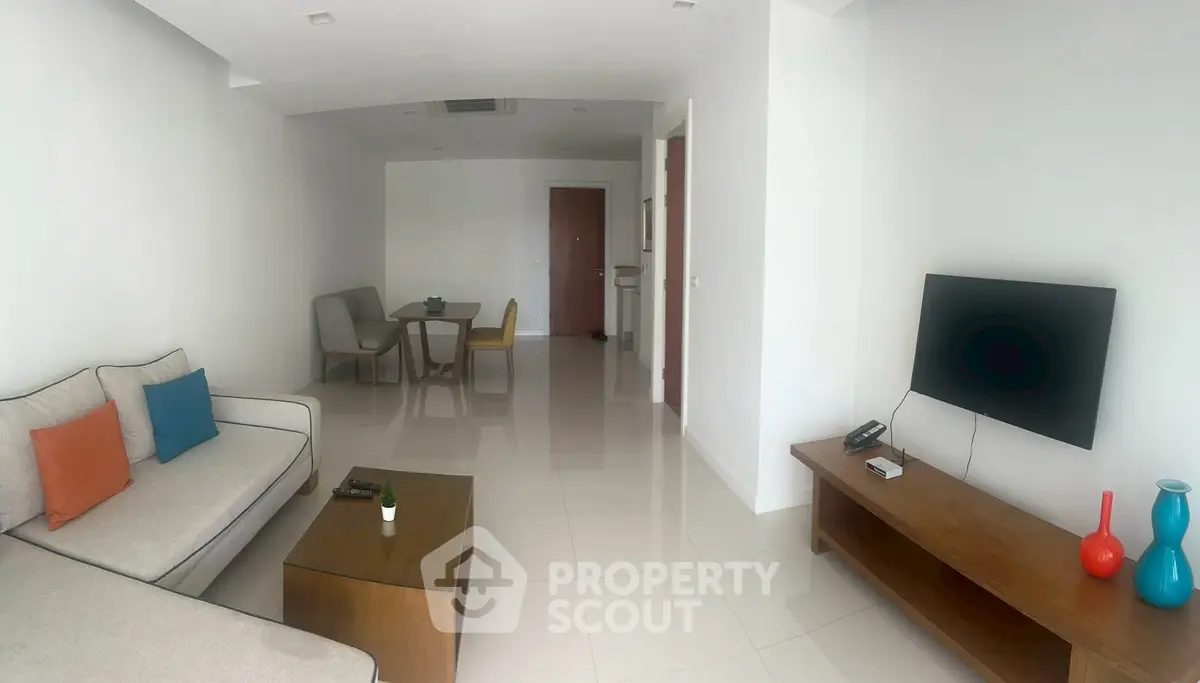 Spacious modern living room with minimalist decor and sleek furniture, perfect for relaxation and entertainment.