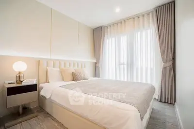 Modern bedroom with elegant decor and large window for natural light.