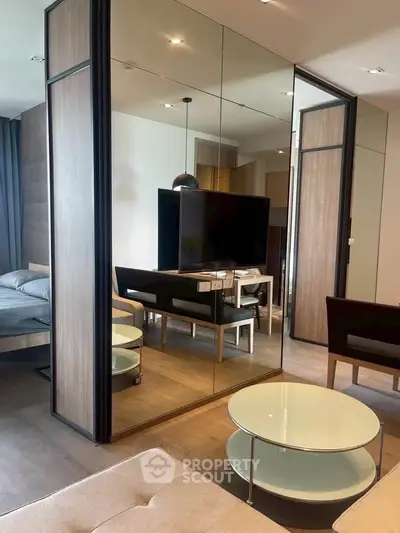 Modern living room with mirrored wall and sleek furniture in stylish apartment
