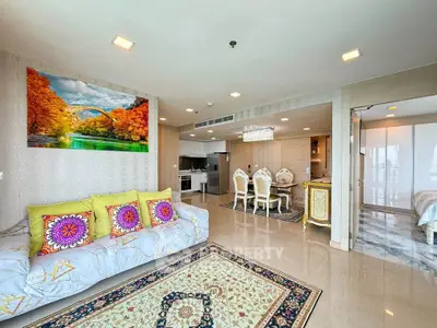 Luxurious open-plan living room with elegant decor and vibrant accents