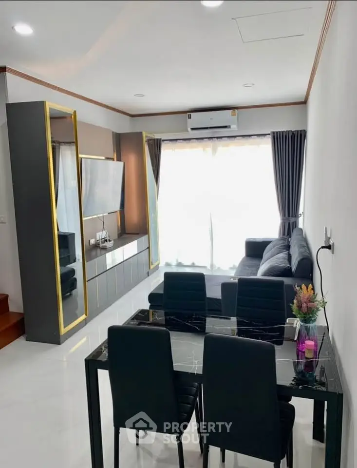 Modern living room with sleek furniture and natural light, perfect for stylish urban living.