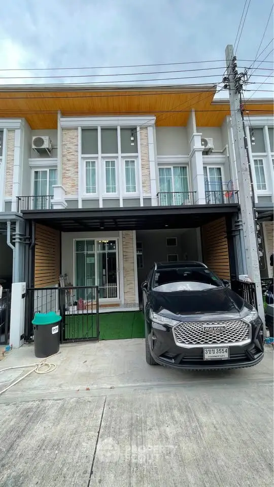 Modern townhouse exterior with carport and sleek design