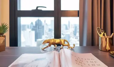 Stylish home office with city view, featuring elegant decor and modern furnishings.