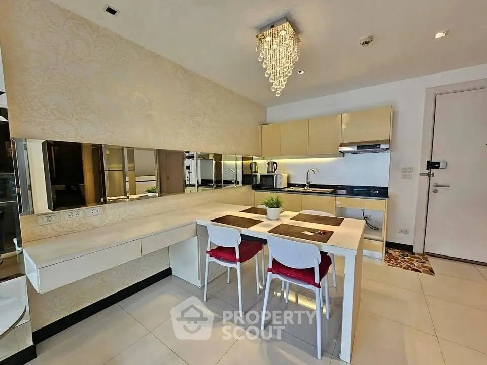 Modern dining area with elegant chandelier and sleek kitchen design