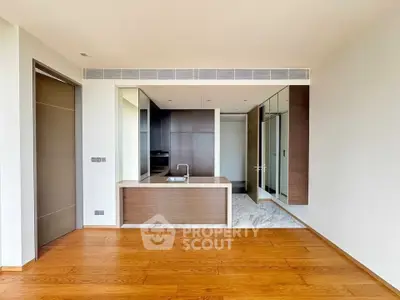 Modern open kitchen with sleek design and wooden flooring