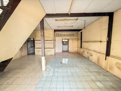 Spacious open-plan interior with tiled flooring and wooden accents, ideal for customization.