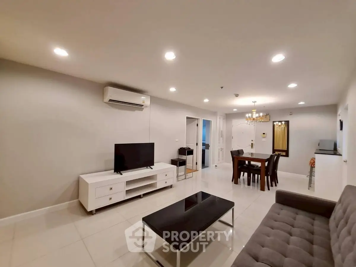 Spacious modern living room with elegant dining area and sleek furniture