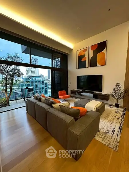 Luxurious modern living room with large windows and city view, featuring stylish decor and spacious seating.