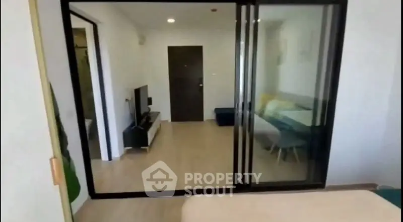 Modern apartment interior with sliding glass doors and cozy living area