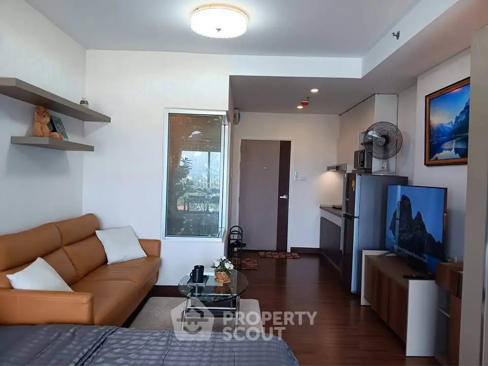 Modern living room with stylish decor and open kitchen layout in a cozy apartment.