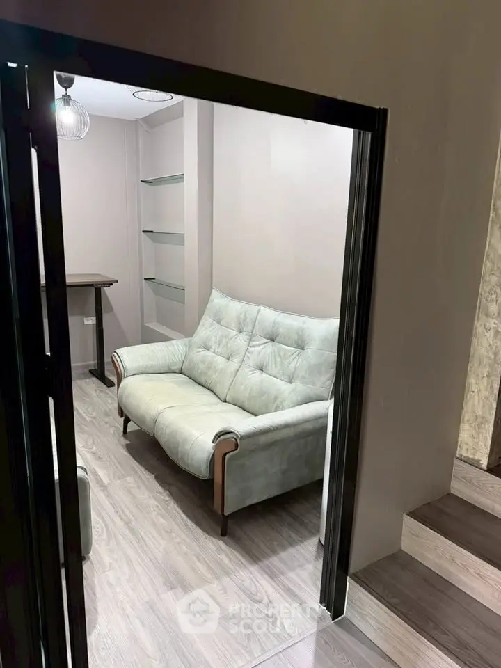 Cozy study room with modern sofa and sleek wooden flooring