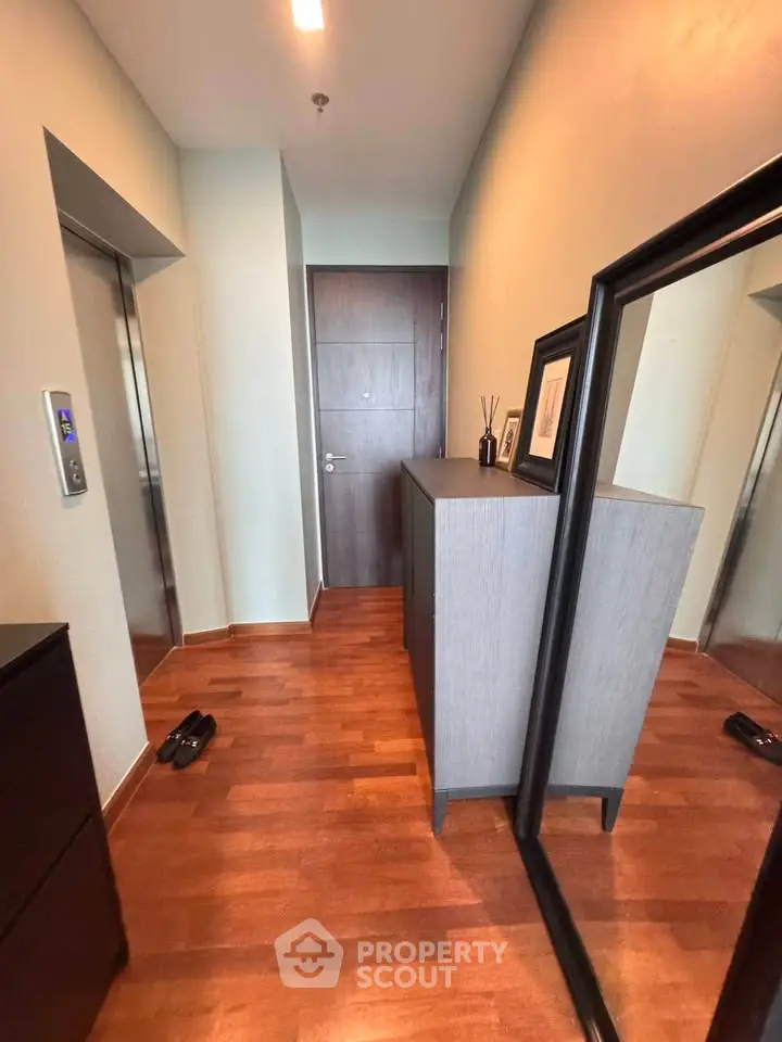 Stylish apartment entrance with wooden flooring and modern decor