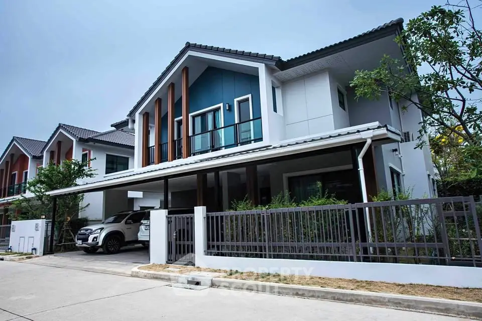 Modern two-story house with carport and stylish facade in suburban neighborhood.