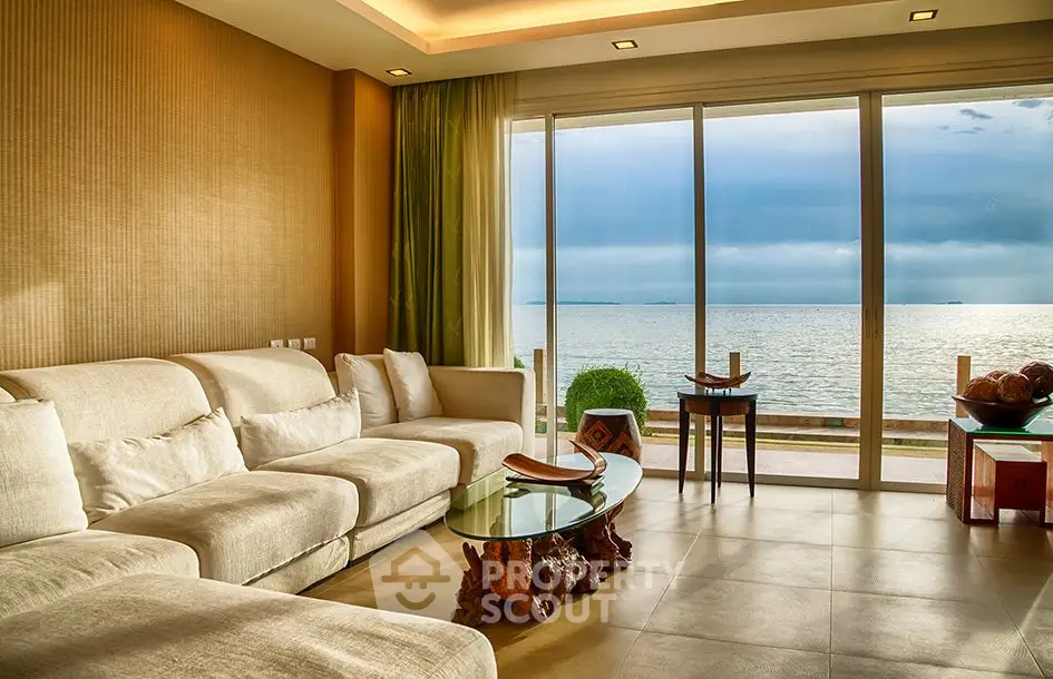 Luxurious living room with stunning ocean view and elegant furnishings.